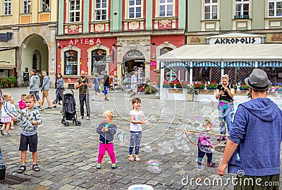 Street entertainer â€“ playing with children, making soap bubbles Editorial Stock Photo